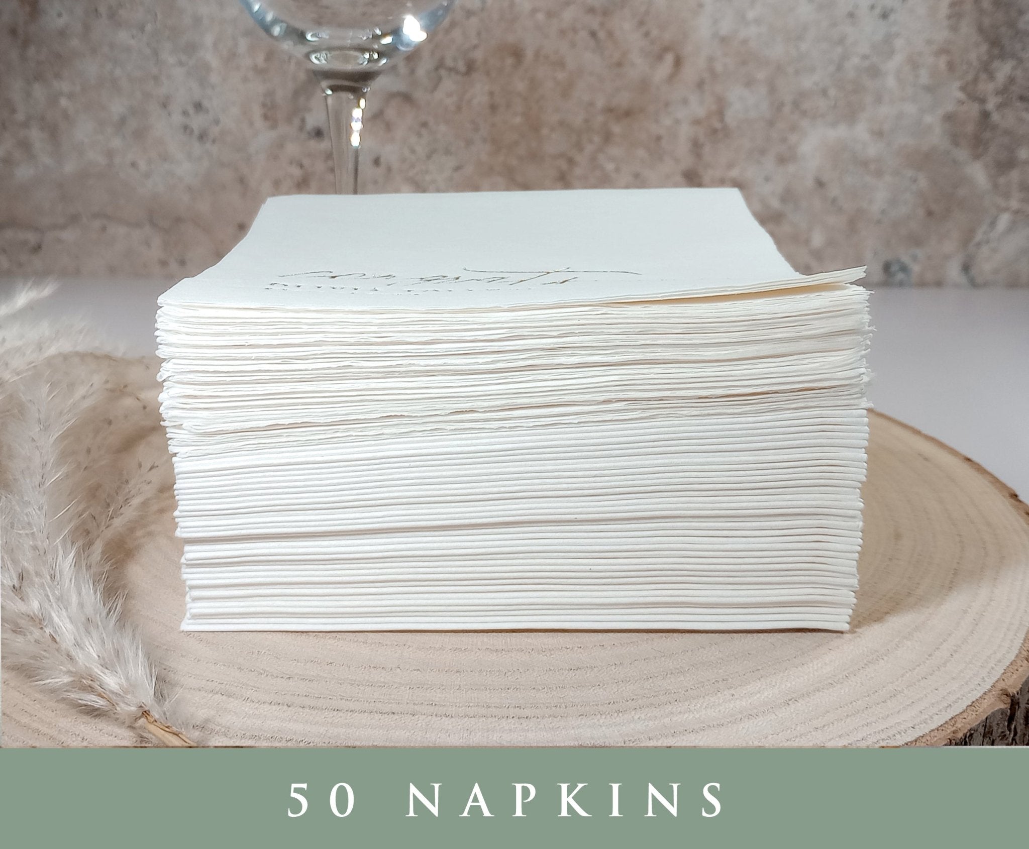Set of 50 custom wedding napkins stacked neatly, showcasing premium 3-ply thickness.