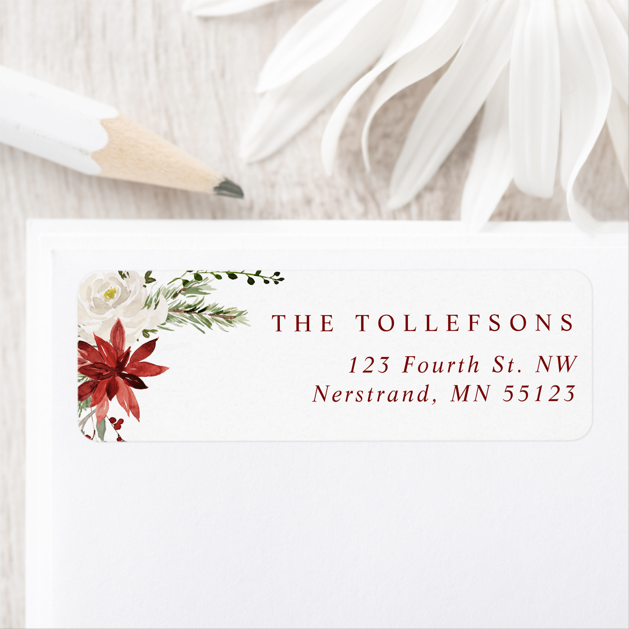 Elegant holiday return address label with watercolor poinsettias, holly berries, and greenery.