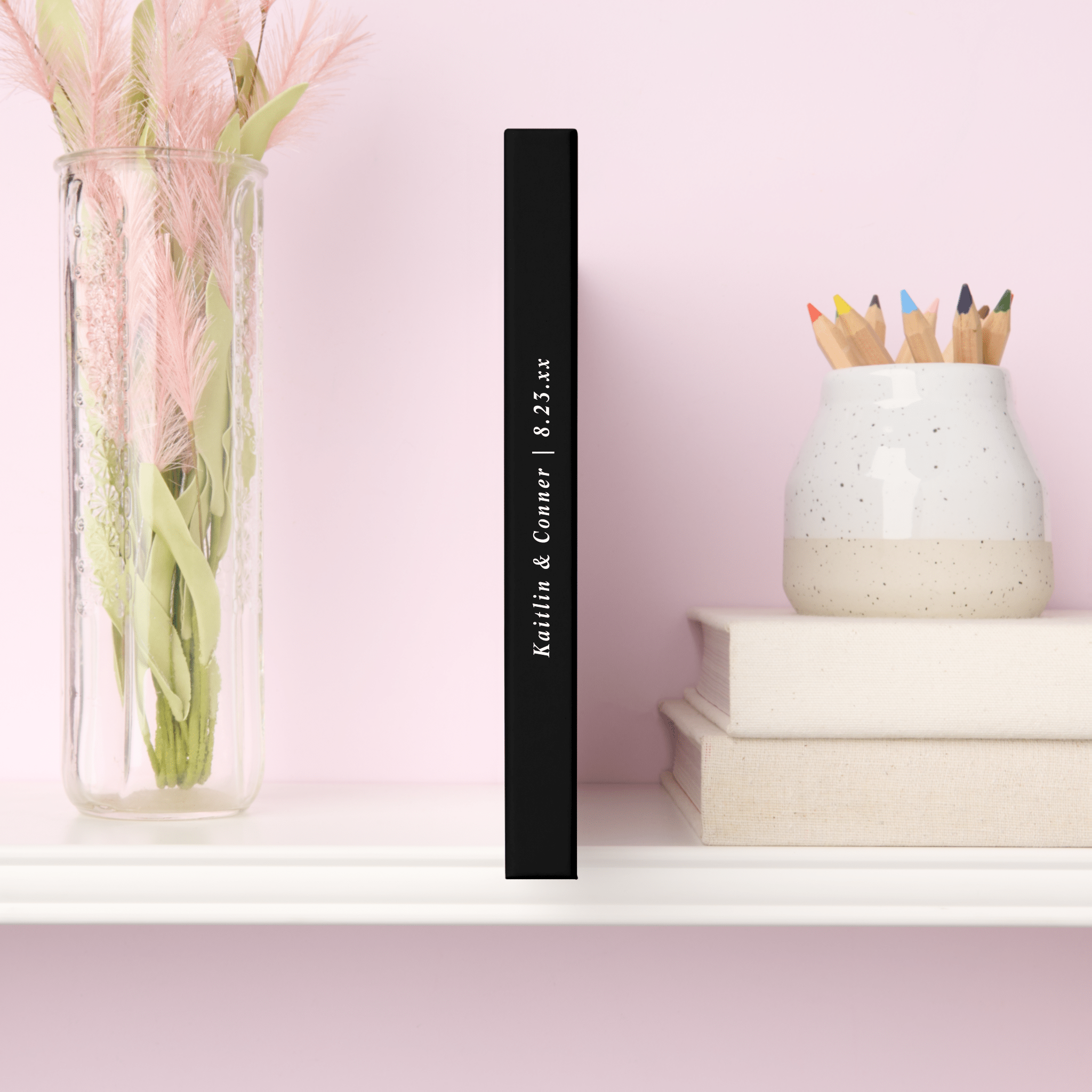 Spine of elegant wedding guest book shown on a shelf