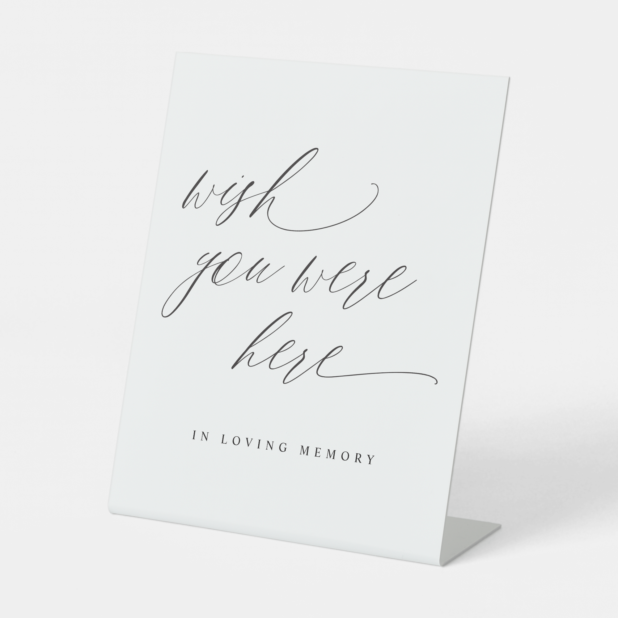 Memorial sign with 'wish you were here' text on a white background