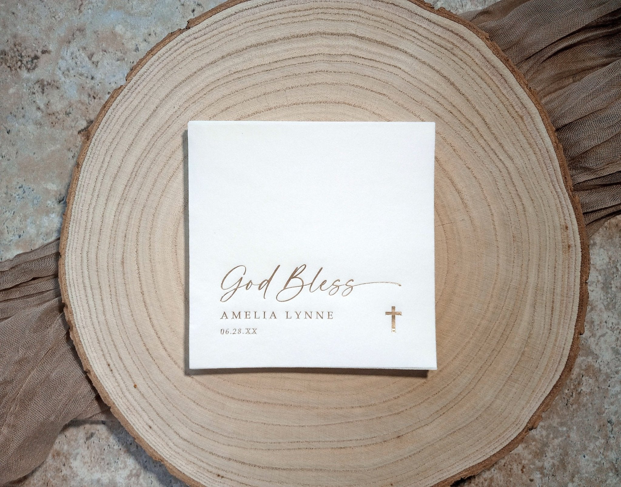 Elegant beverage napkin in gold foil for child’s baptism celebration