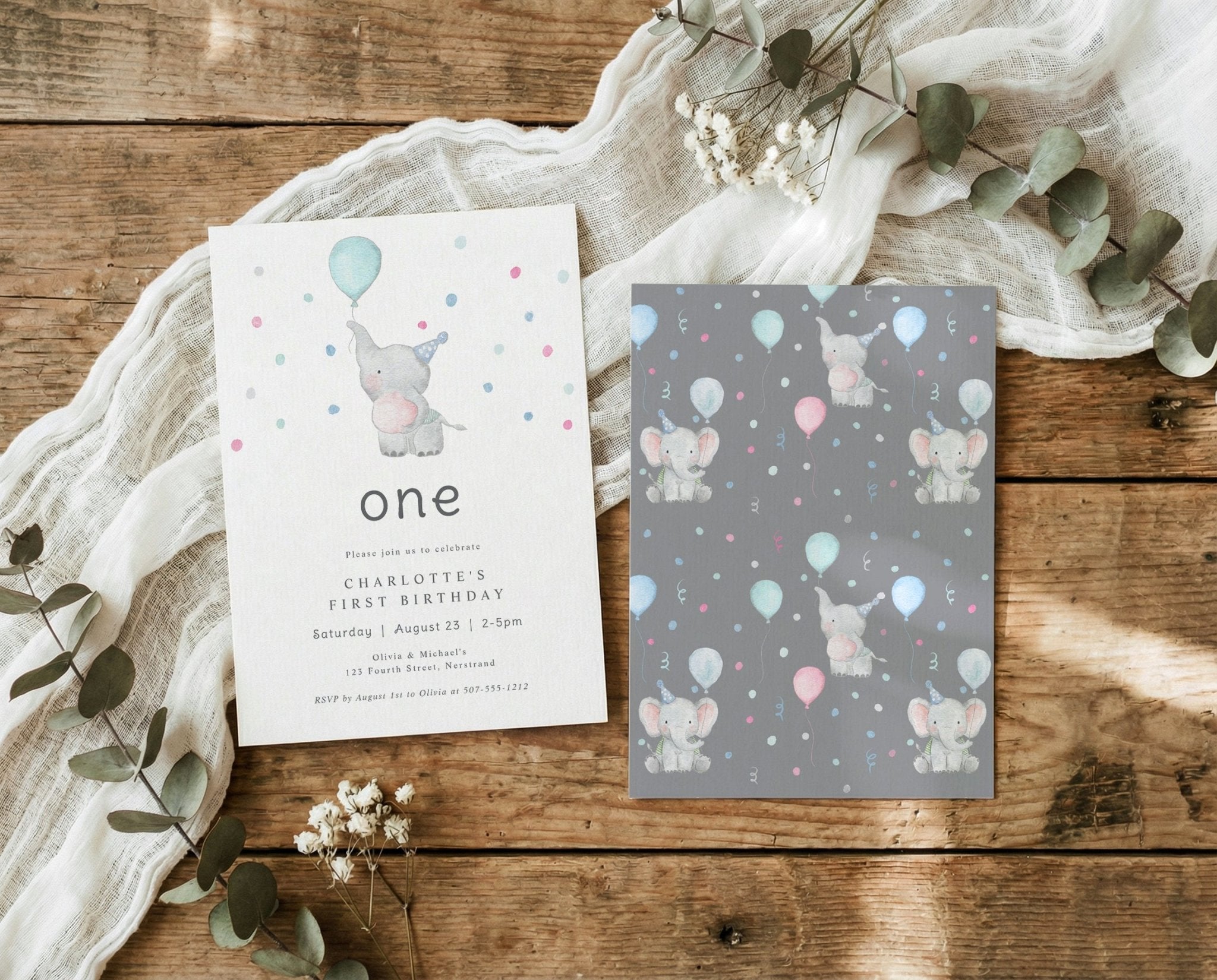 Two birthday invitations with elephants and balloons on a wooden surface with eucalyptus leaves.