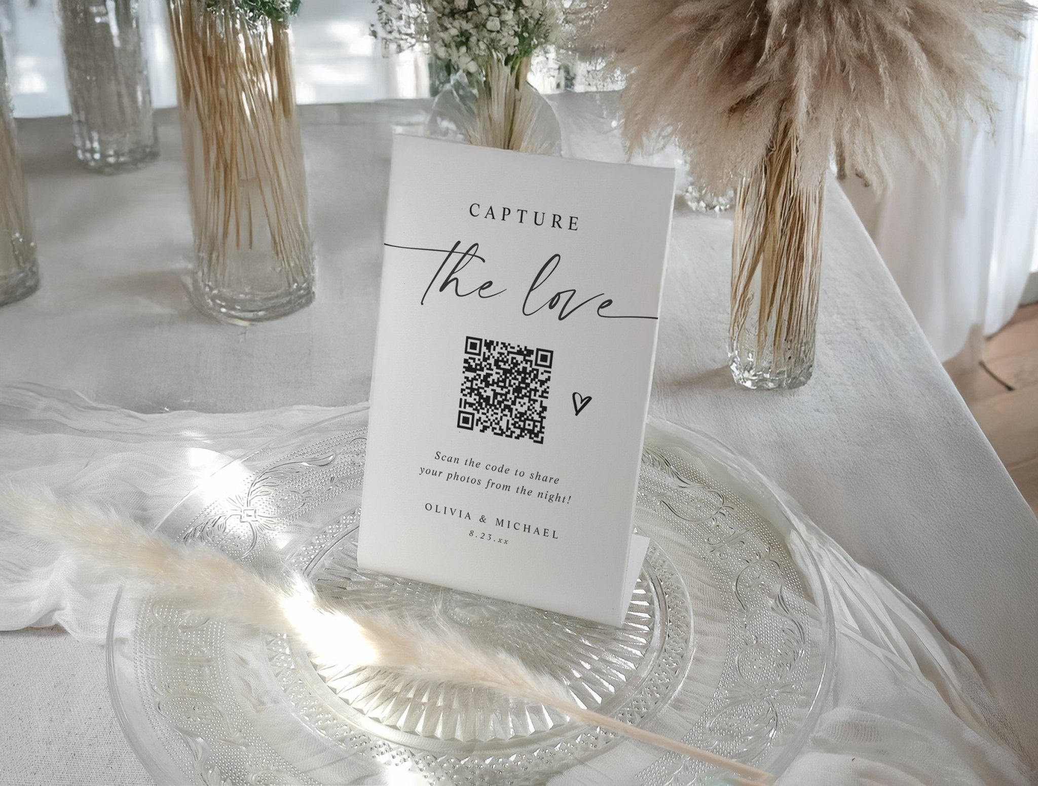 Modern wedding QR code sign with elegant handwritten script and heart for guest photo sharing.
