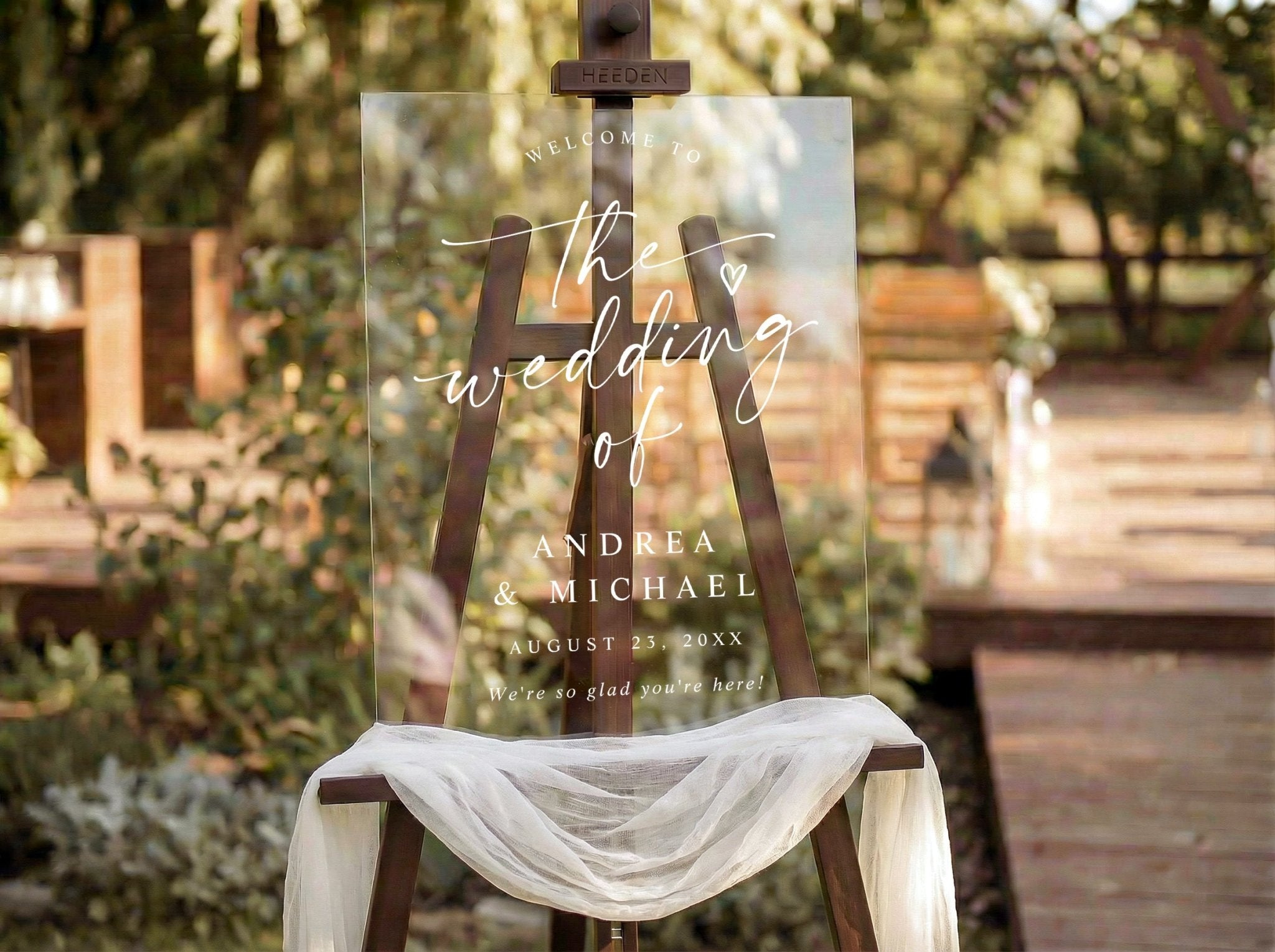 Acrylic wedding sign on a wooden easel with outdoor setting