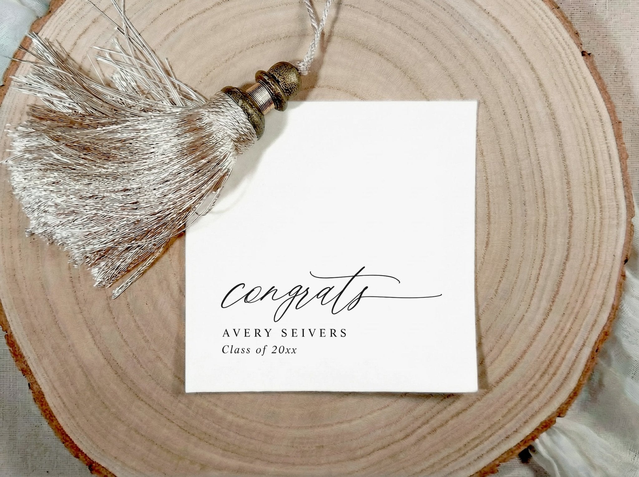Graduation congratulations napkin with tassel on a wooden surface