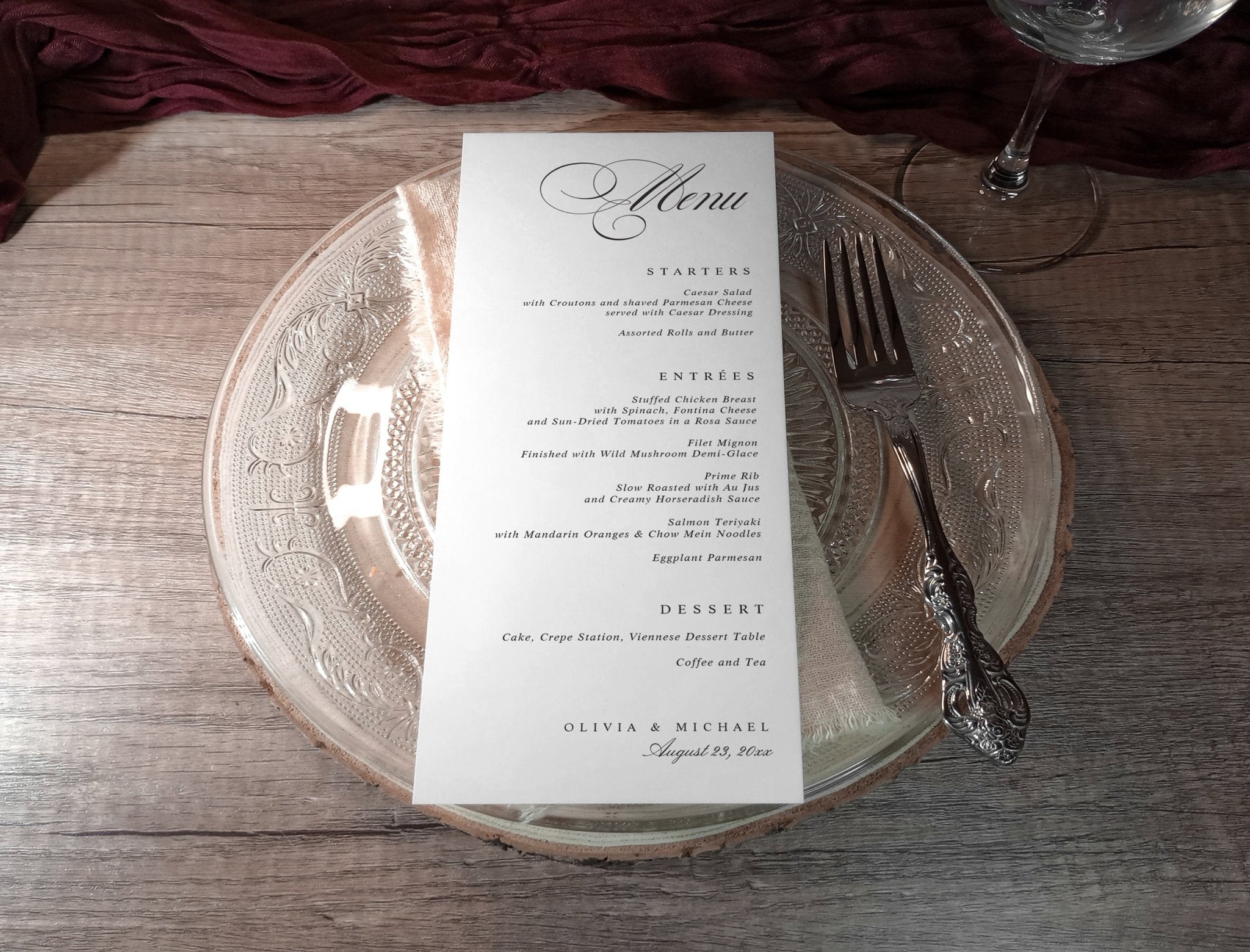 Elegant menu card on a glass plate with silverware on a wooden table