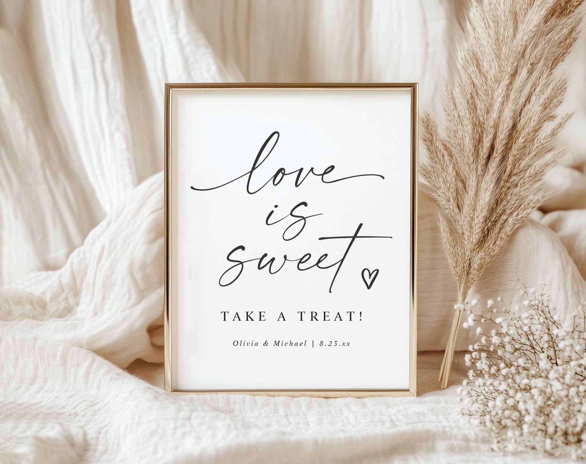 Framed print with 'Love is sweet, take a treat!' text on a soft fabric background