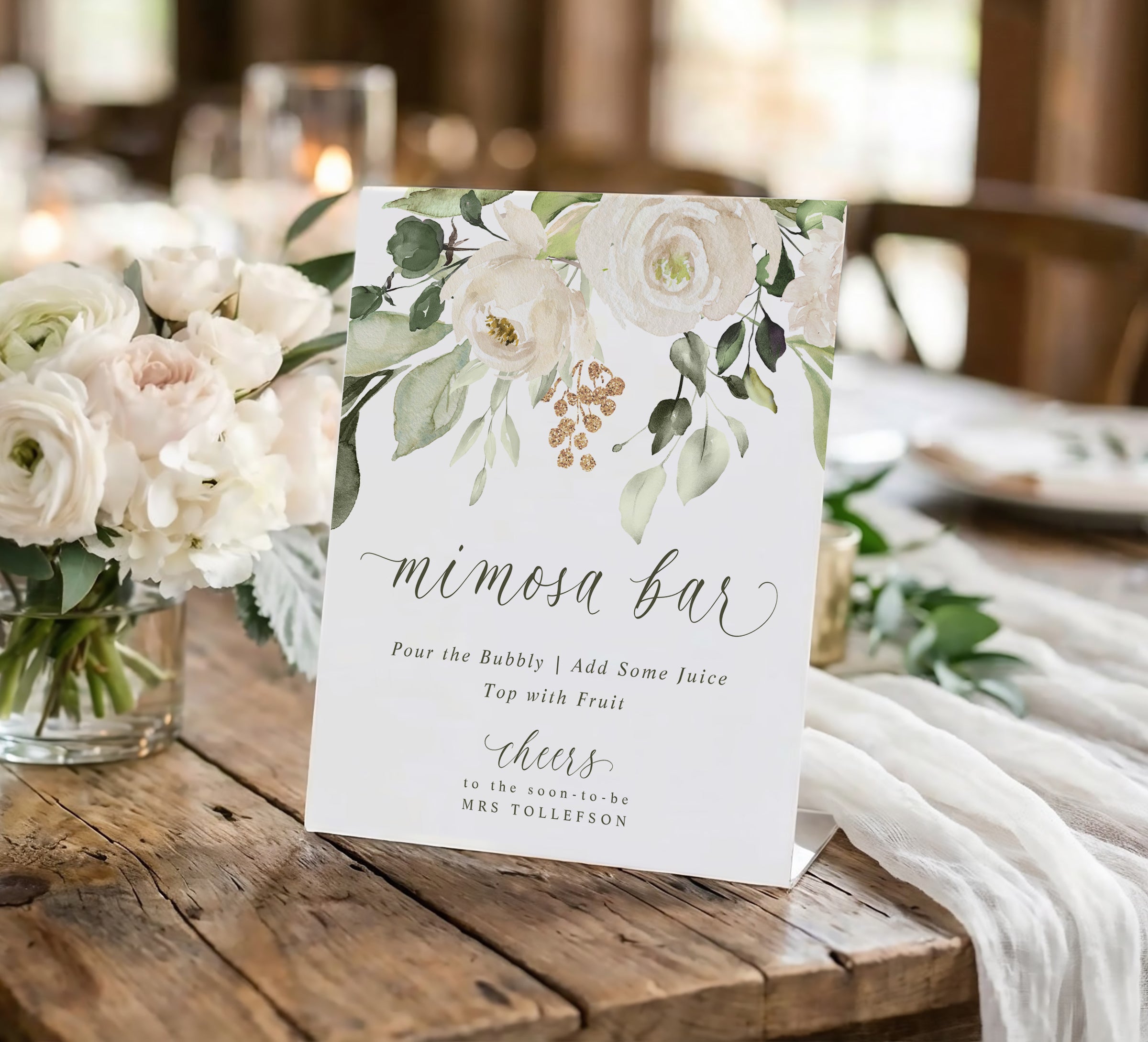 Mimosa bar sign with floral design on a wooden table with flowers and tablecloth.