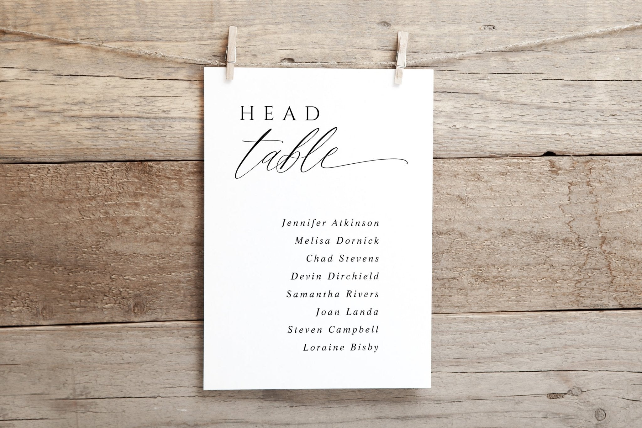 White card with 'HEAD TABLE' text and names on a wooden background