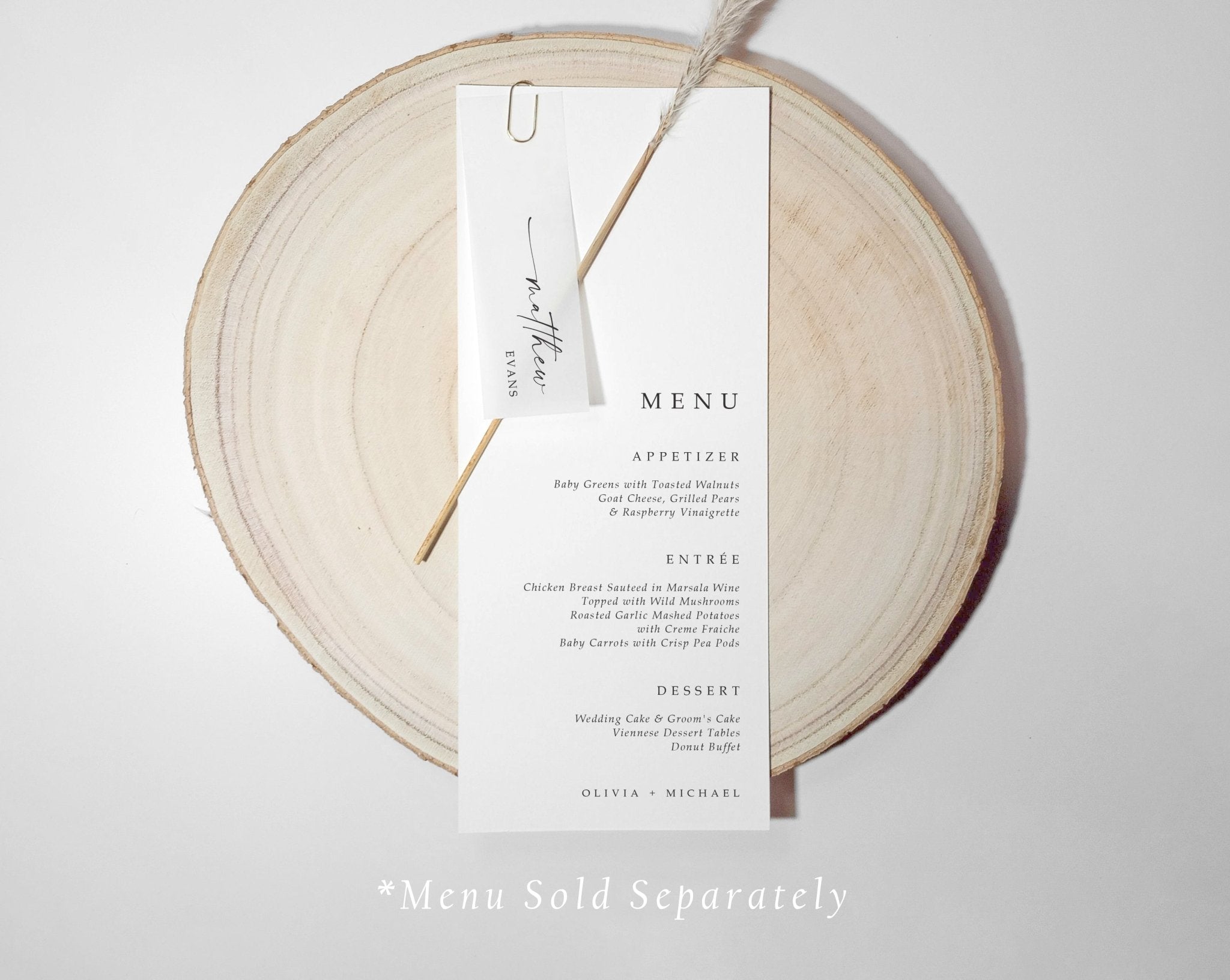 Translucent name tag clipped to wedding menu on wood background, perfect for formal place settings.