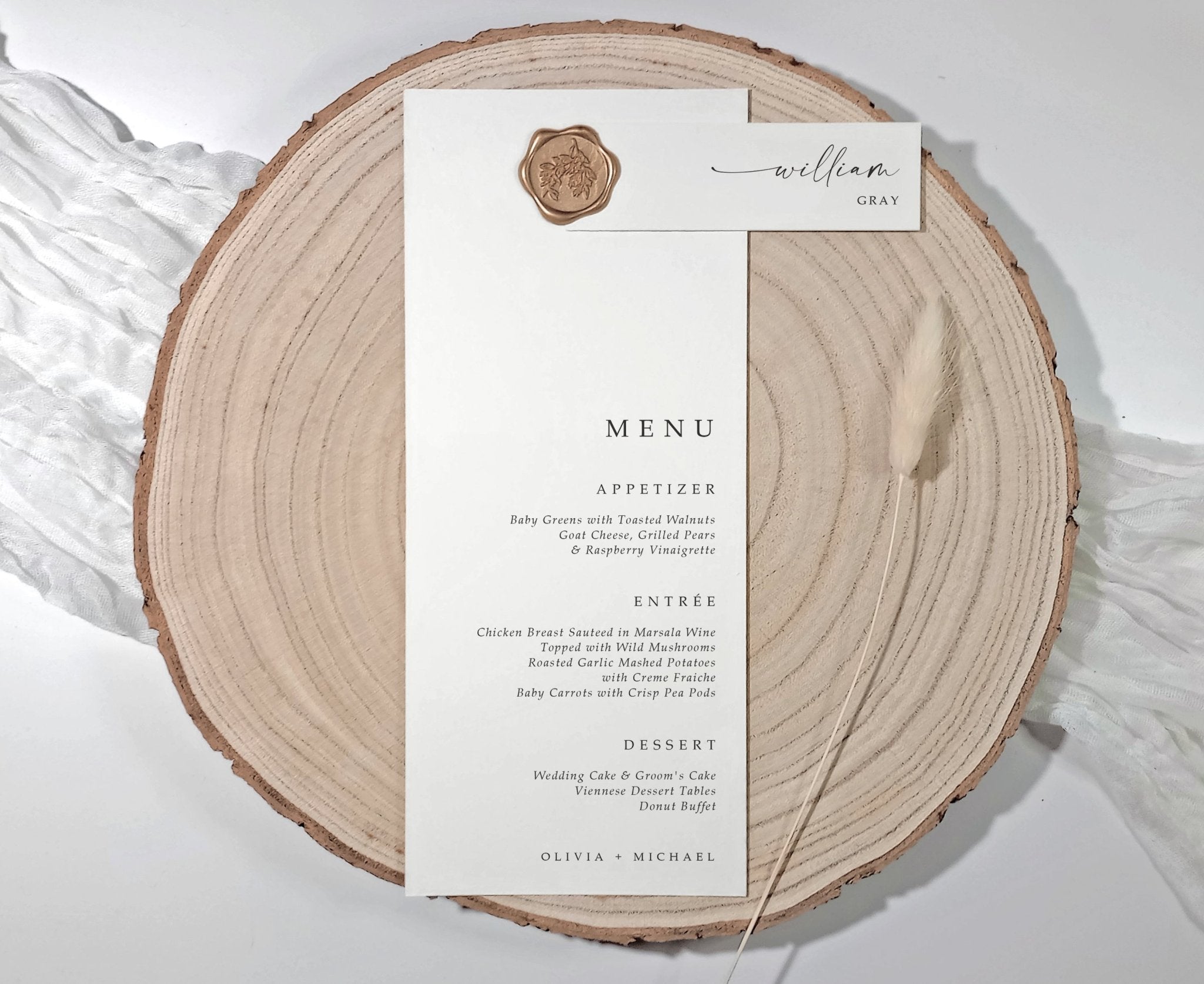 Wedding menu styled with a wax-sealed vellum tag layered on wood round — tag and menu sold separately.
