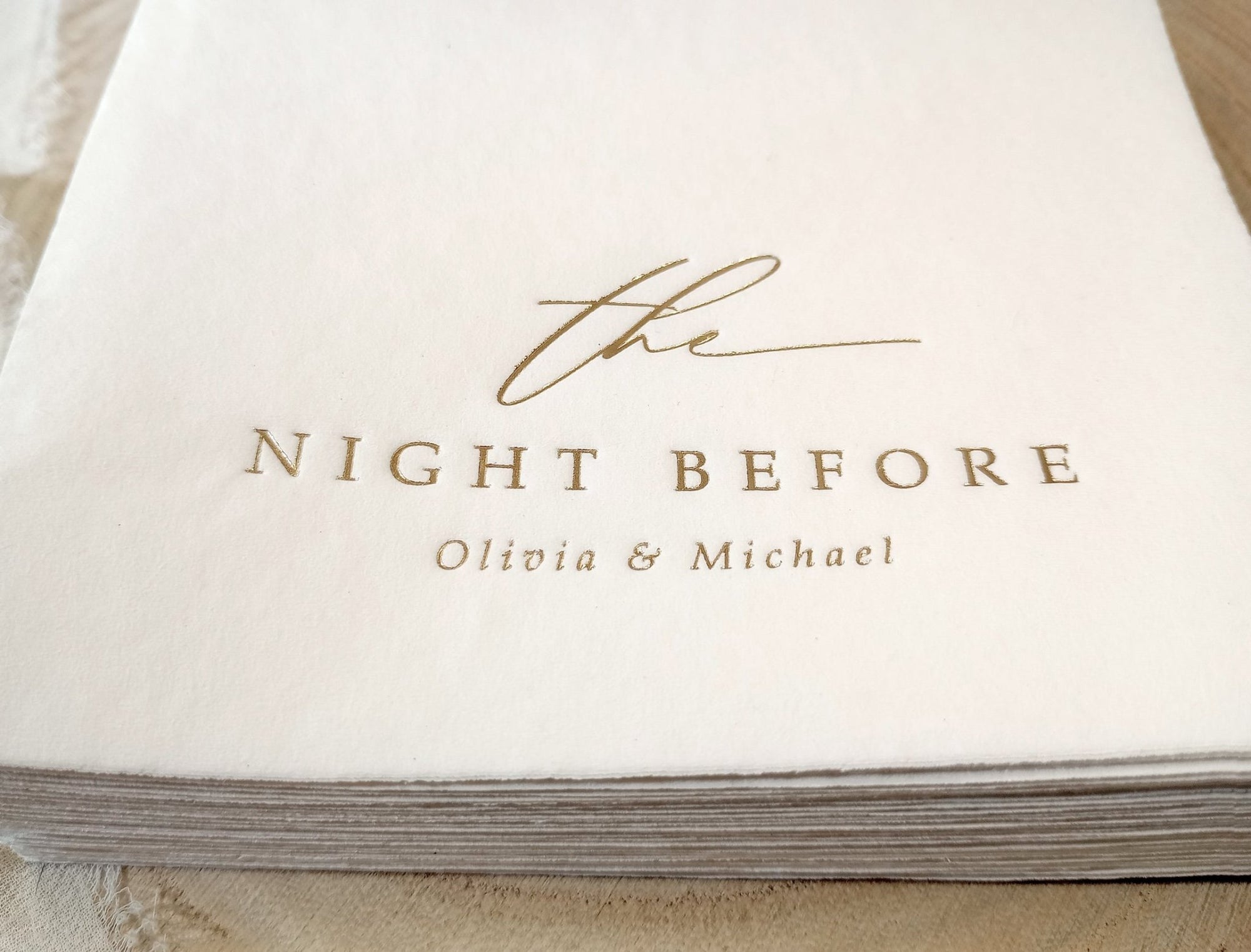 Custom foil-stamped cocktail napkin with elegant script reading ‘the night before’ — perfect for rehearsal dinners or wedding welcome parties.
