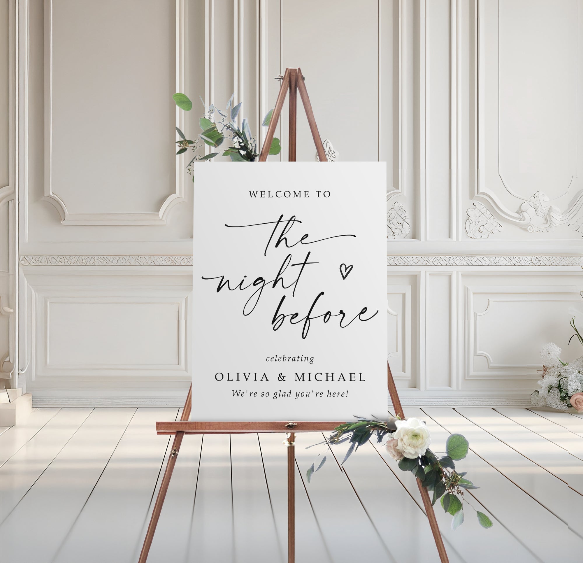 Rehearsal Dinner welcome sign on an easel with floral decorations in a elegant room.