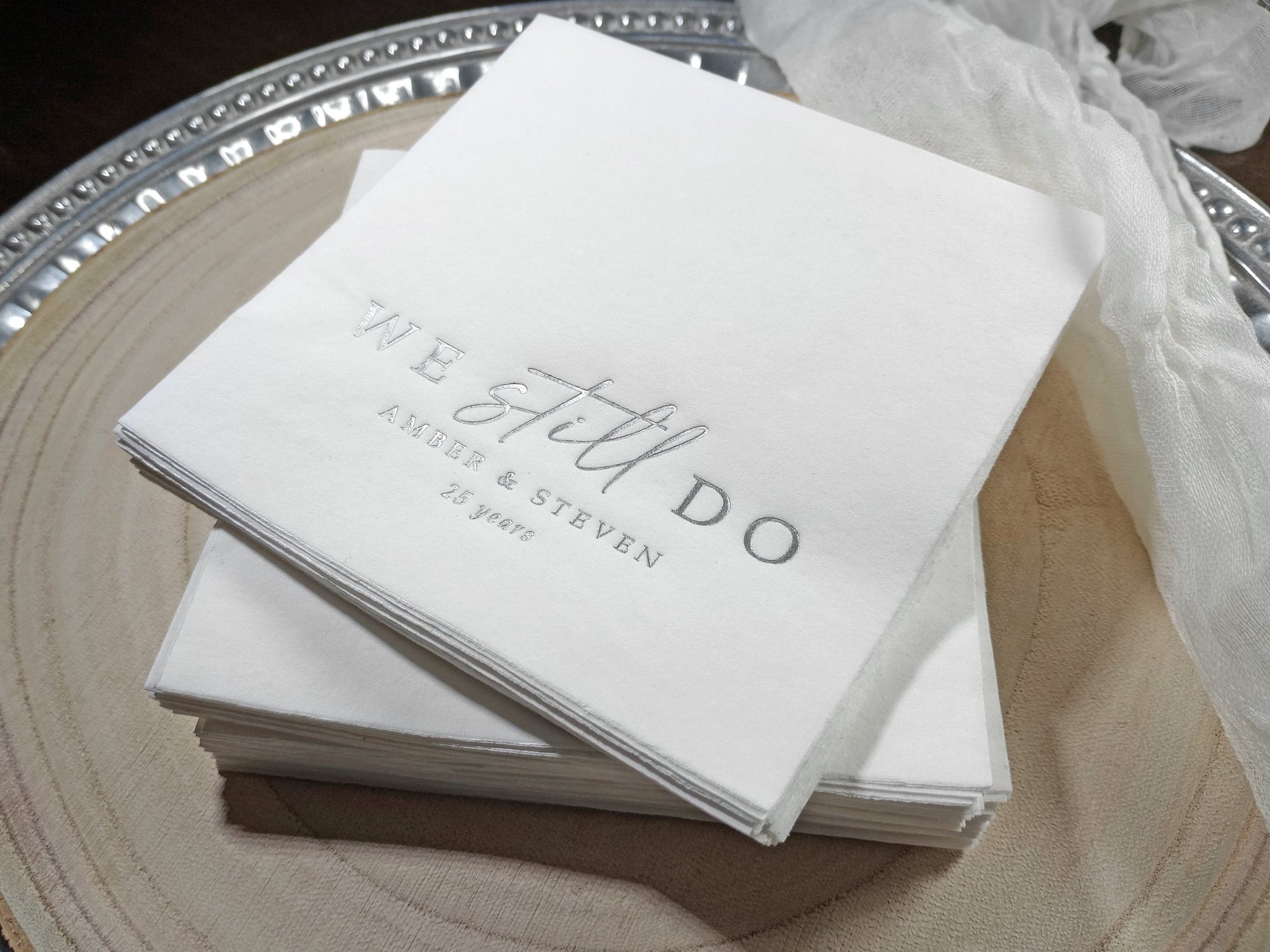 stack of foil stamped napkins for wedding anniversary celebration