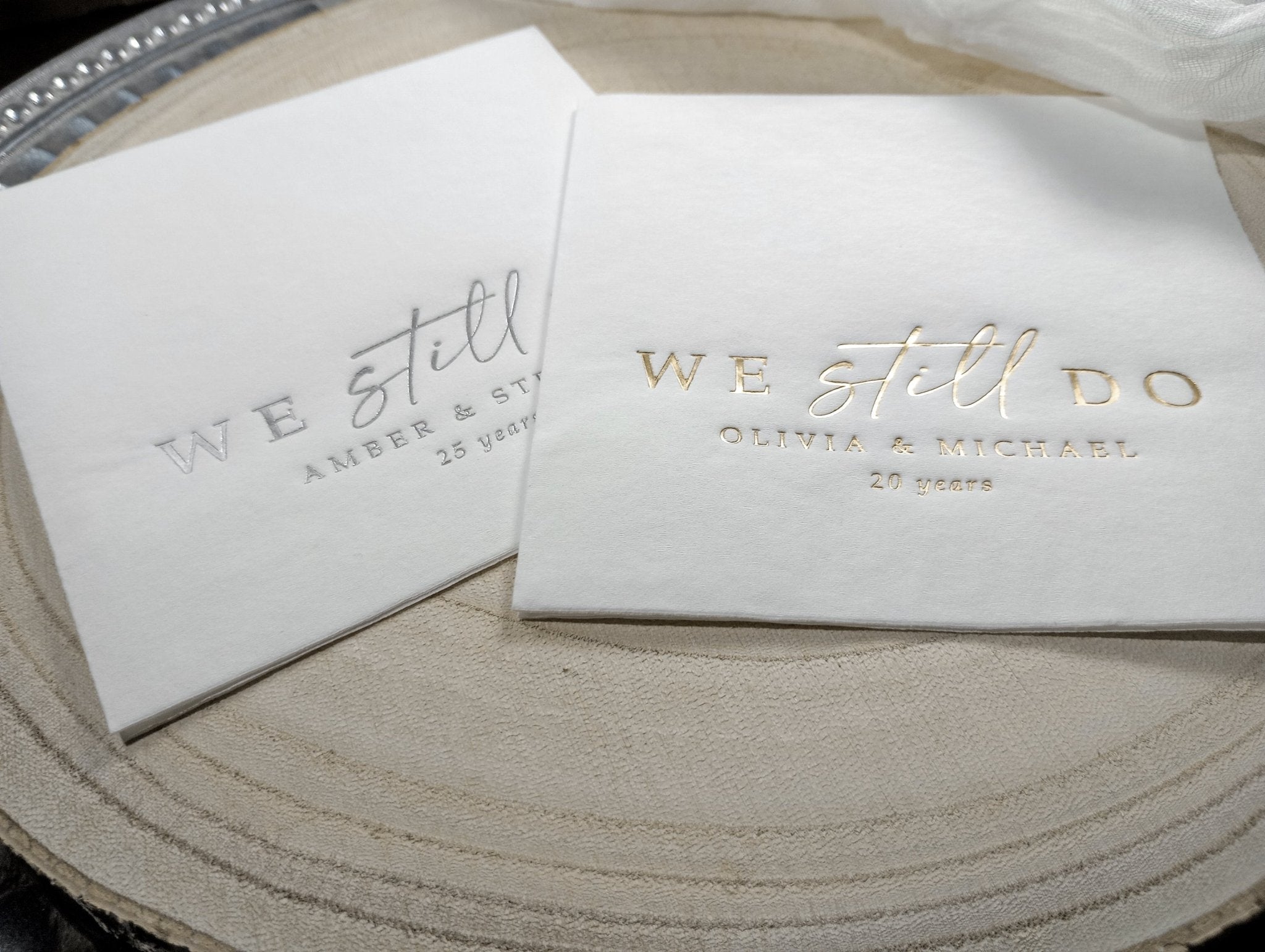 anniversary napkins in modern calligraphy script with couple’s names and years