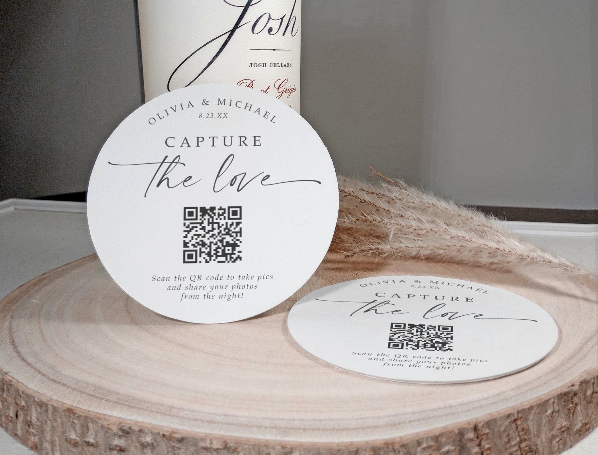 Modern QR code coasters for weddings, displayed on wood with pampas grass, featuring personalized wedding QR code.