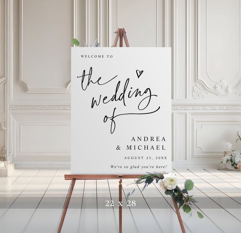 Wedding welcome sign on an easel with decorative elements in a room with white paneled walls.