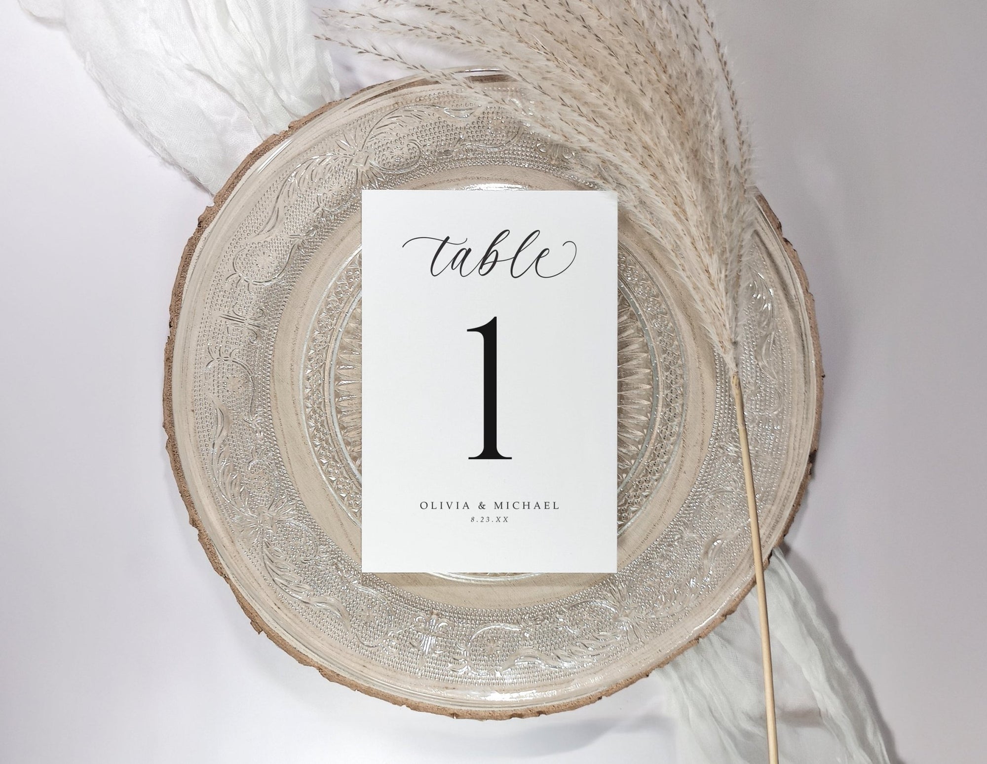 Table number card on a decorative plate with a white background