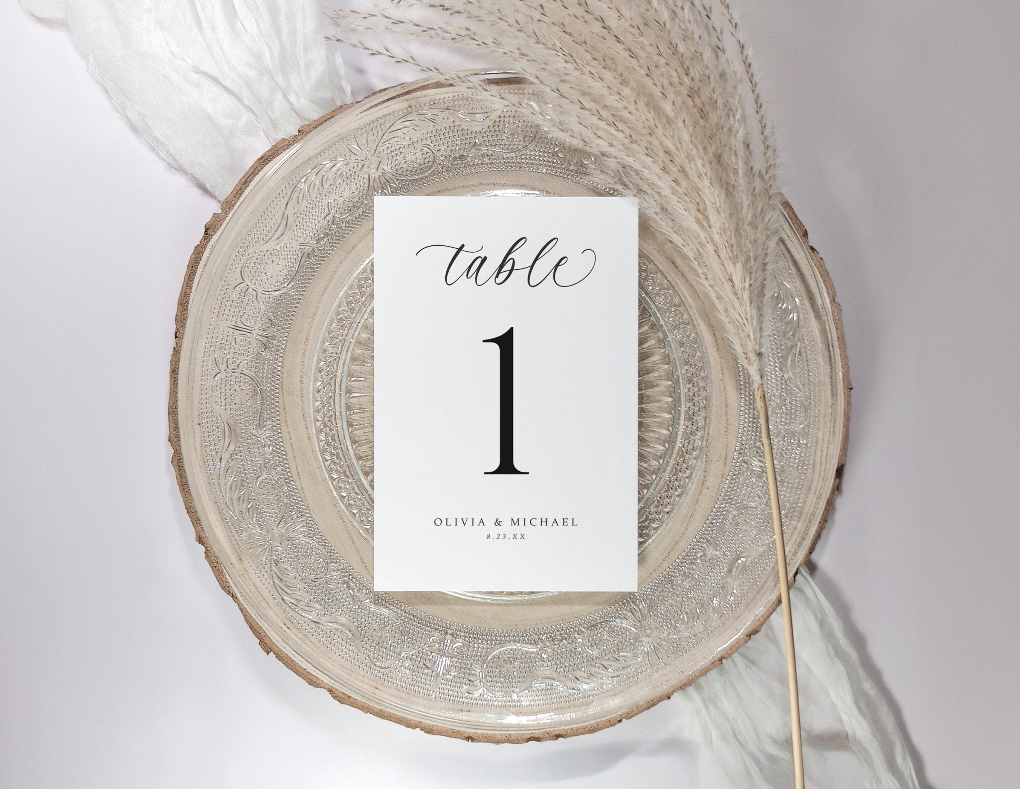 Table number card on a decorative plate with a white background