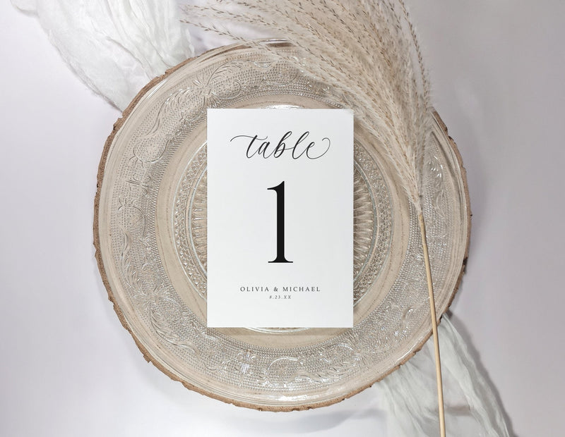 Table number card on a decorative plate with a white background