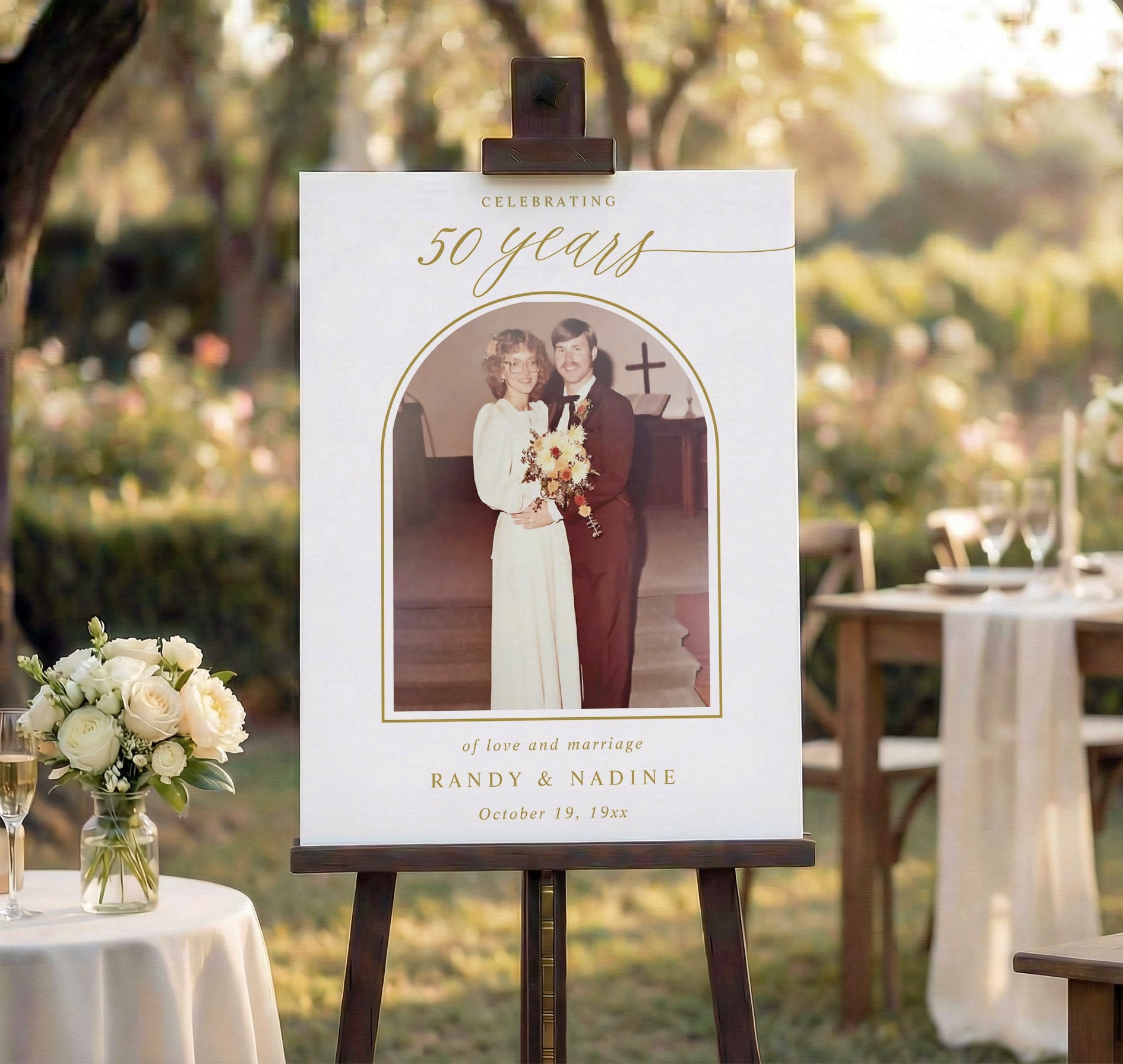 Anniversary celebration with a photo of a couple on a white board in an outdoor setting.