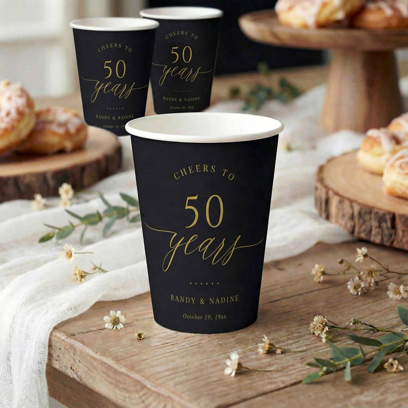 Black and gold 50th wedding anniversary paper cups with script typography
