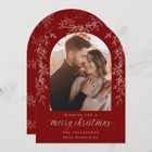 Christmas card with a red arch frame featuring a couple and text.