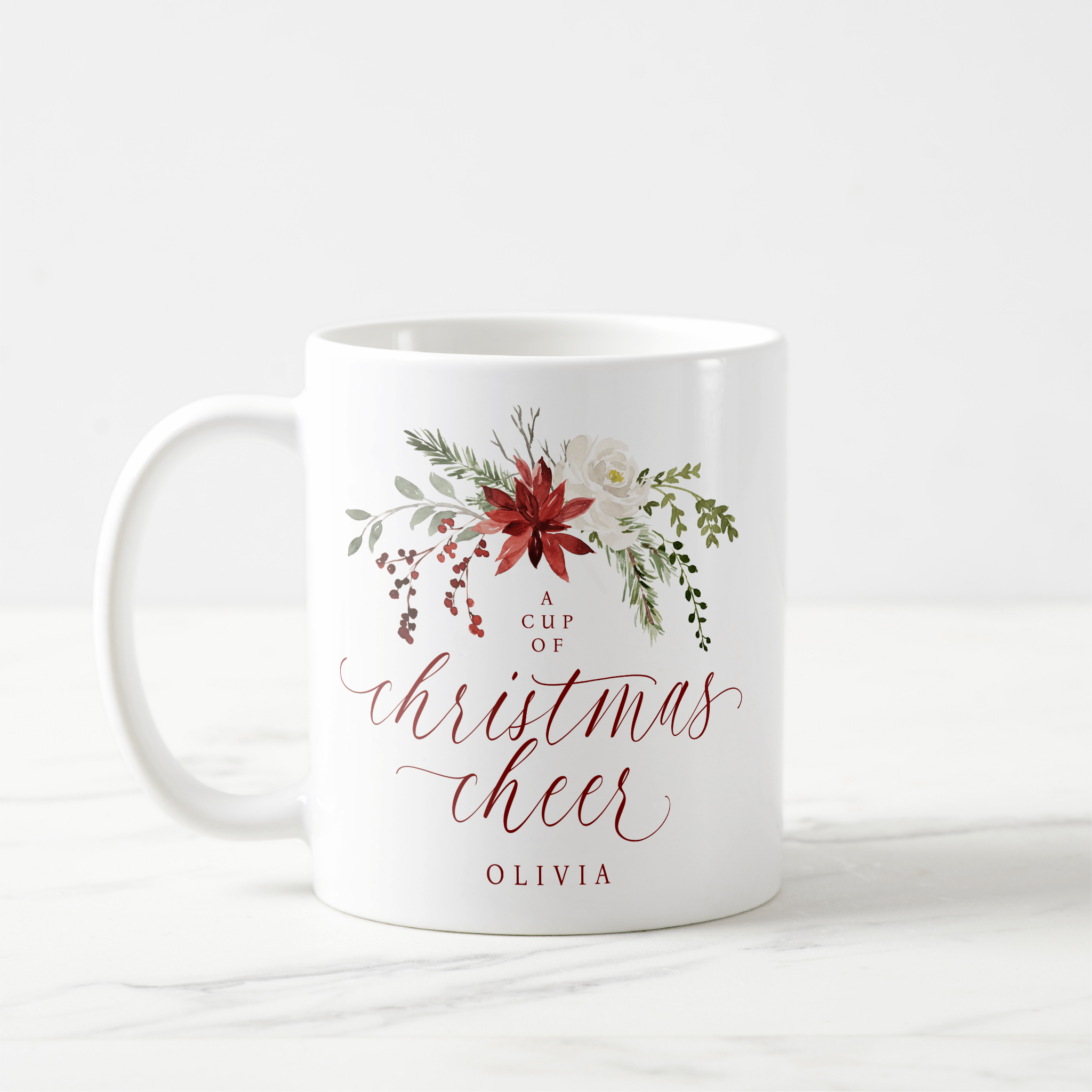 Elegant watercolor Christmas mug with red and green holly berries and botanical greenery.