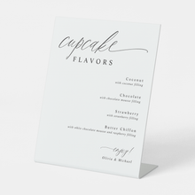 Modern calligraphy cupcake flavors sign displayed at a wedding dessert bar.
