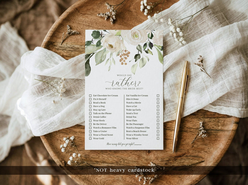 Floral would she rather printed bridal shower game on a wooden surface with a pen and fabric