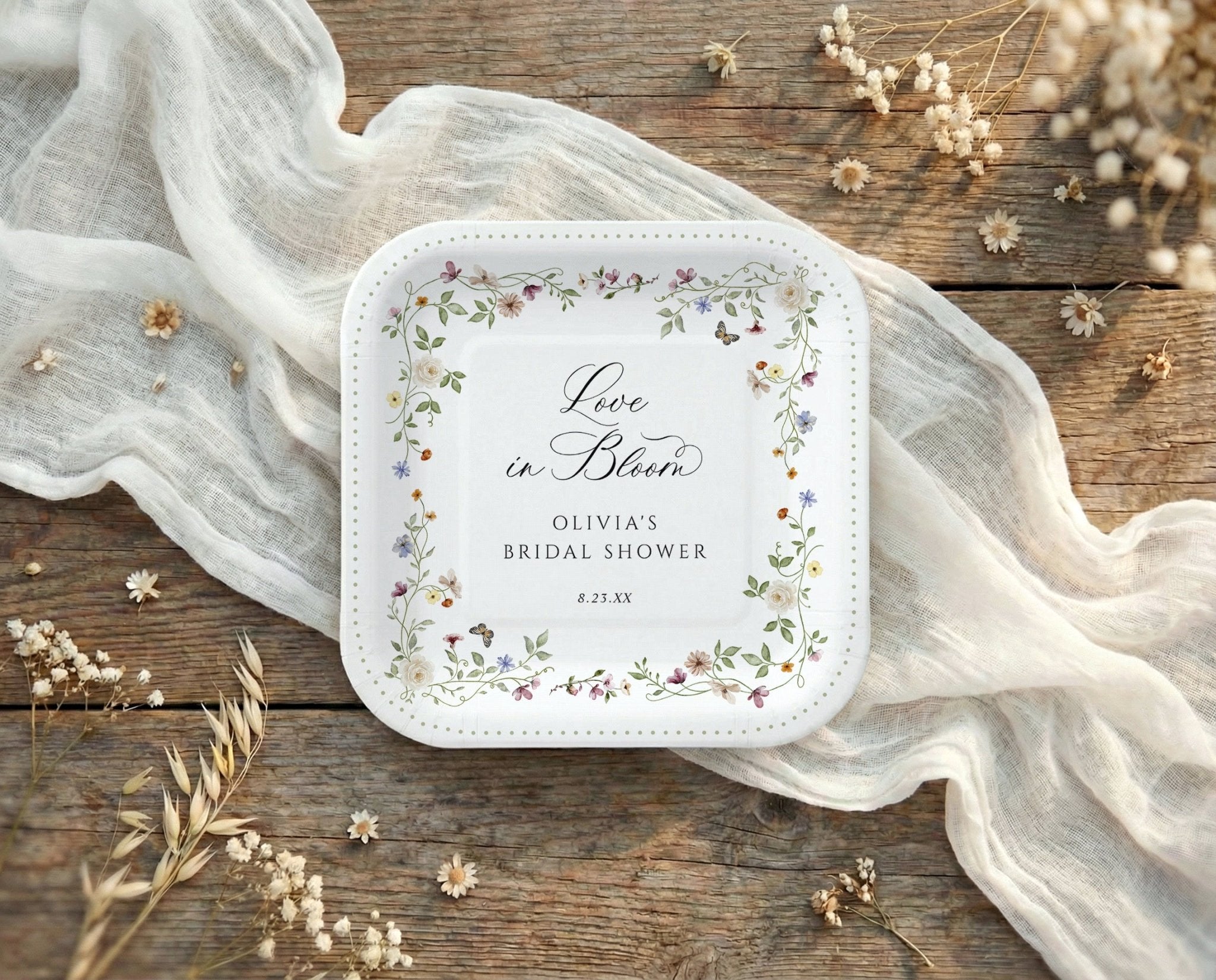 Square bridal shower paper plates with watercolor wildflowers and love is in bloom floral design