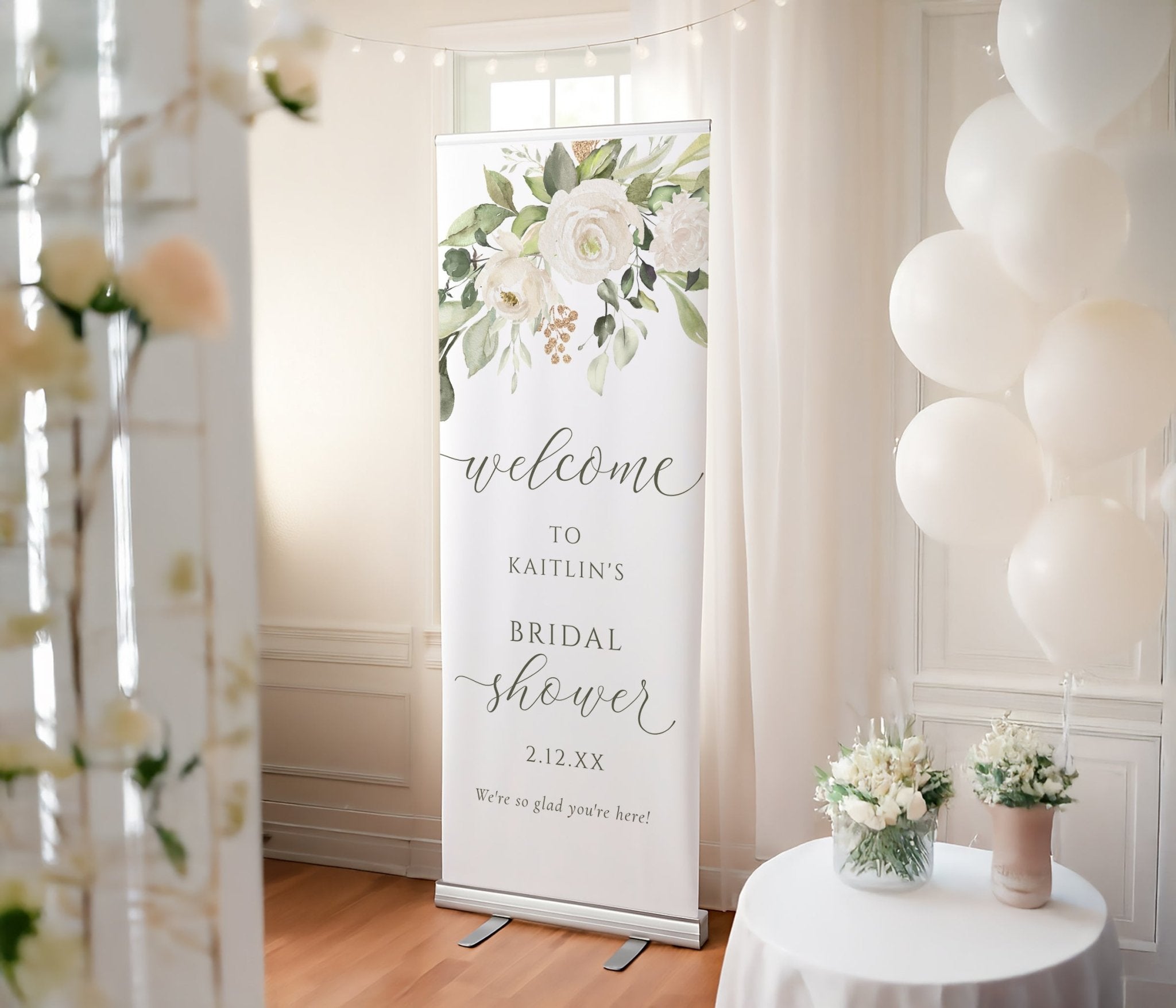 Bridal shower welcome sign with floral design in a decorated room with balloons and flowers.