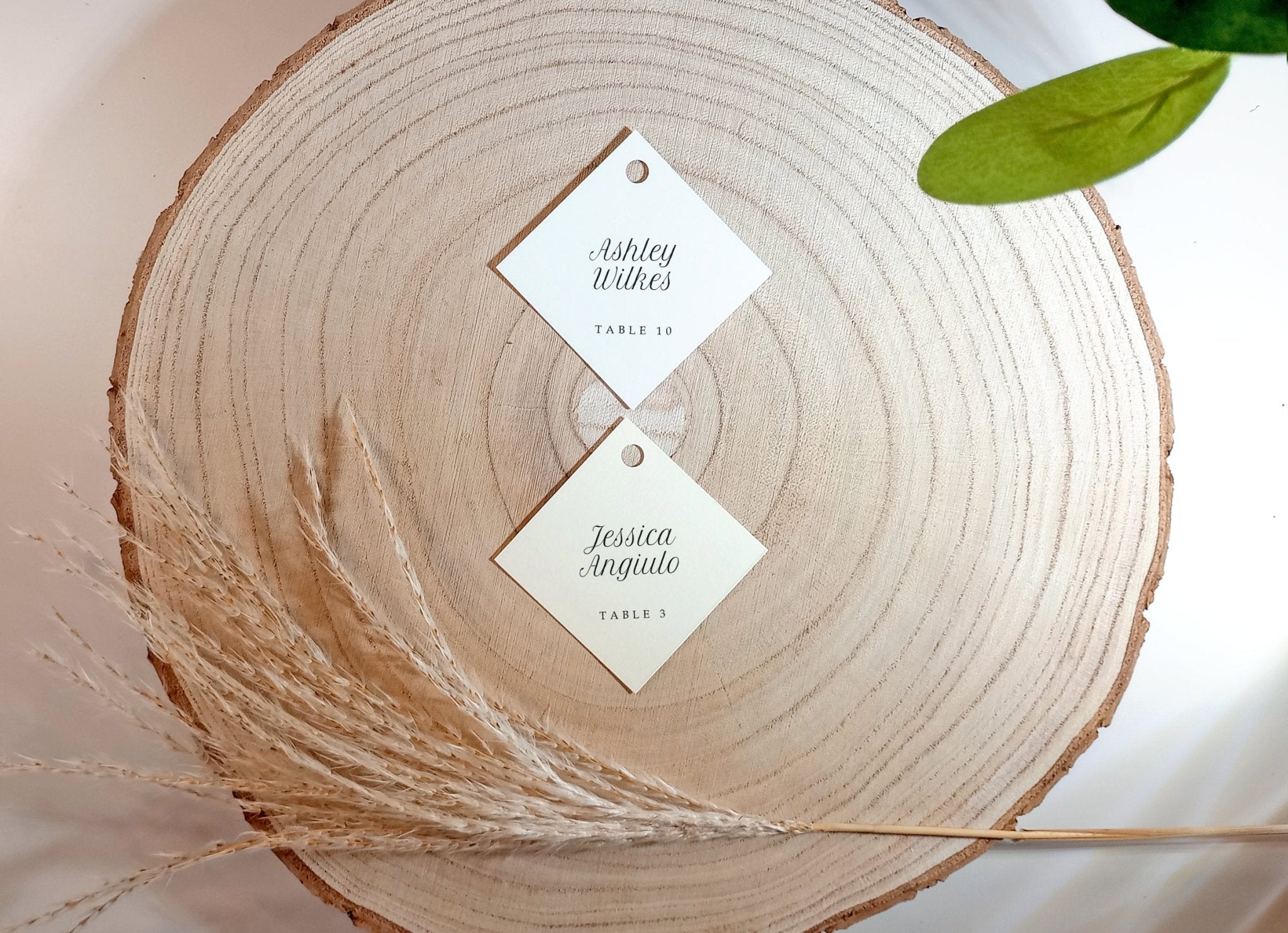 stack of blank diamond-shaped tags on wood background