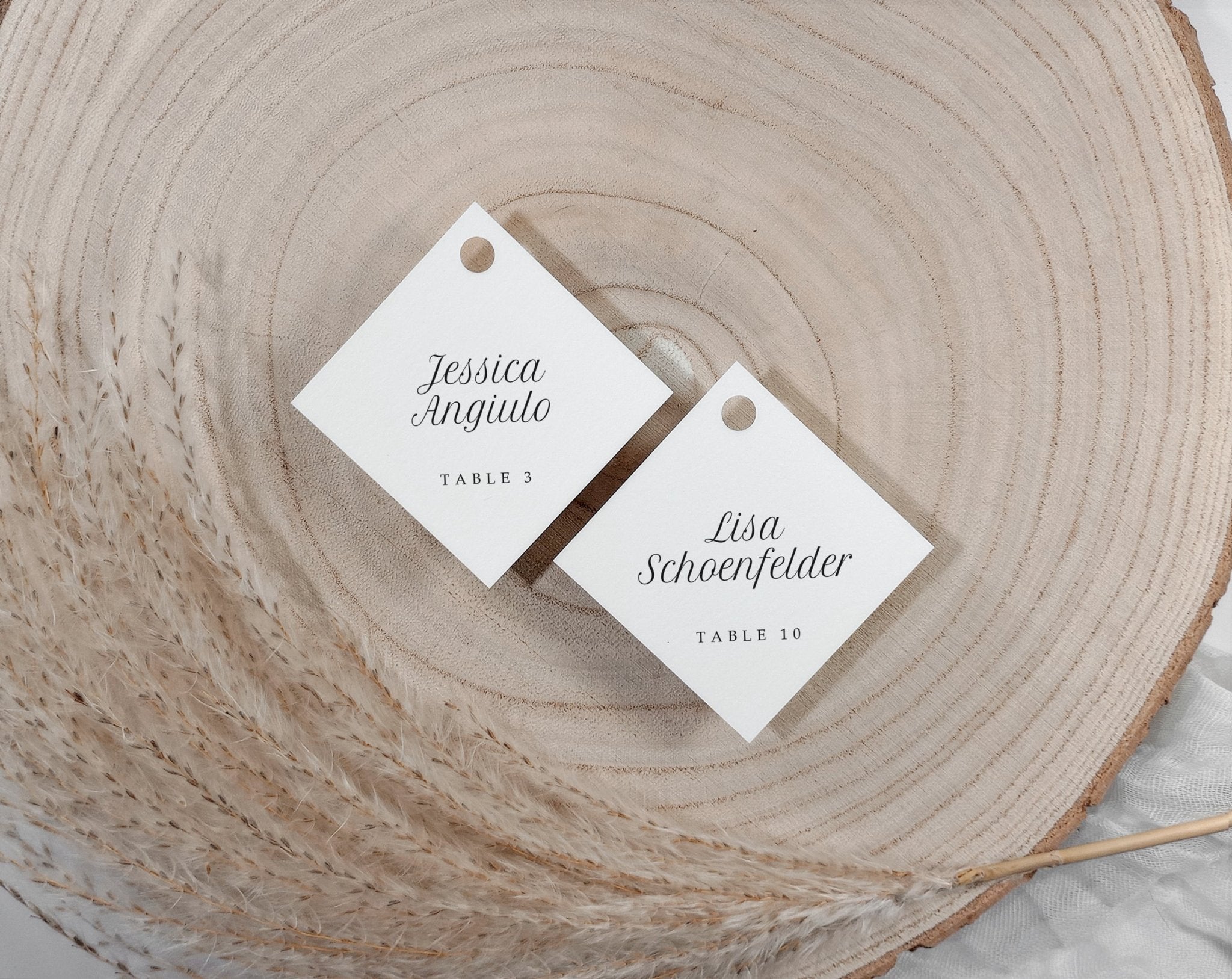 personalized champagne glass name tags for wedding guests styled on wood slice