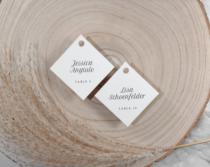 personalized champagne glass name tags for wedding guests styled on wood slice