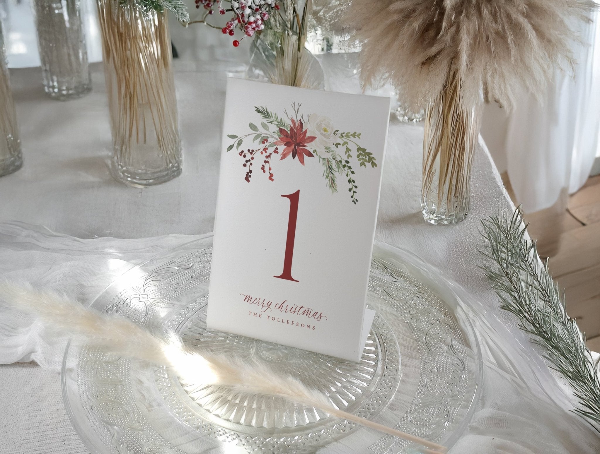 Elegant watercolor Christmas table number with red holly berries and greenery design.