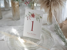 Elegant watercolor Christmas table number with red holly berries and greenery design.