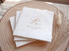 Elegant foil stamped wedding napkins with a script initial and names and wedding date in gold foil.