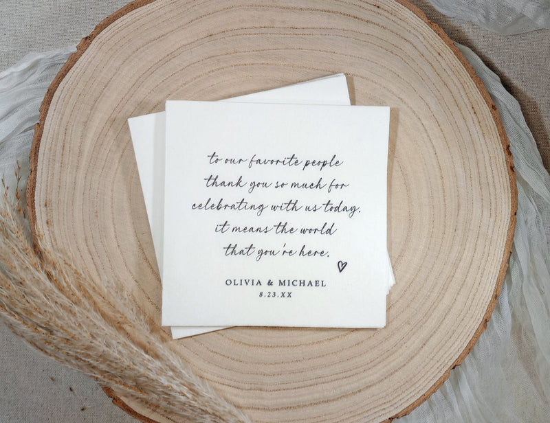 Love note wedding cocktail napkin with black ink message on wood plate