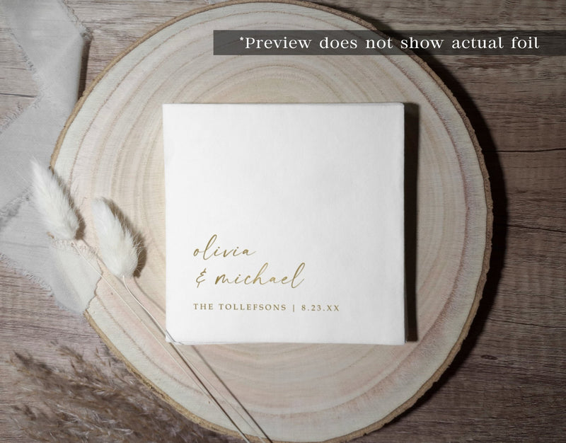 White wedding cocktail napkin with elegant handwriting in gold foil on plate