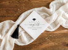 Diagonal graduation napkins with script congrats, stars and graduation cap design