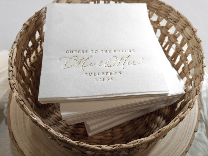 Elegant engagement napkin with “cheers to the future Mr & Mrs” in gold foil calligraphy