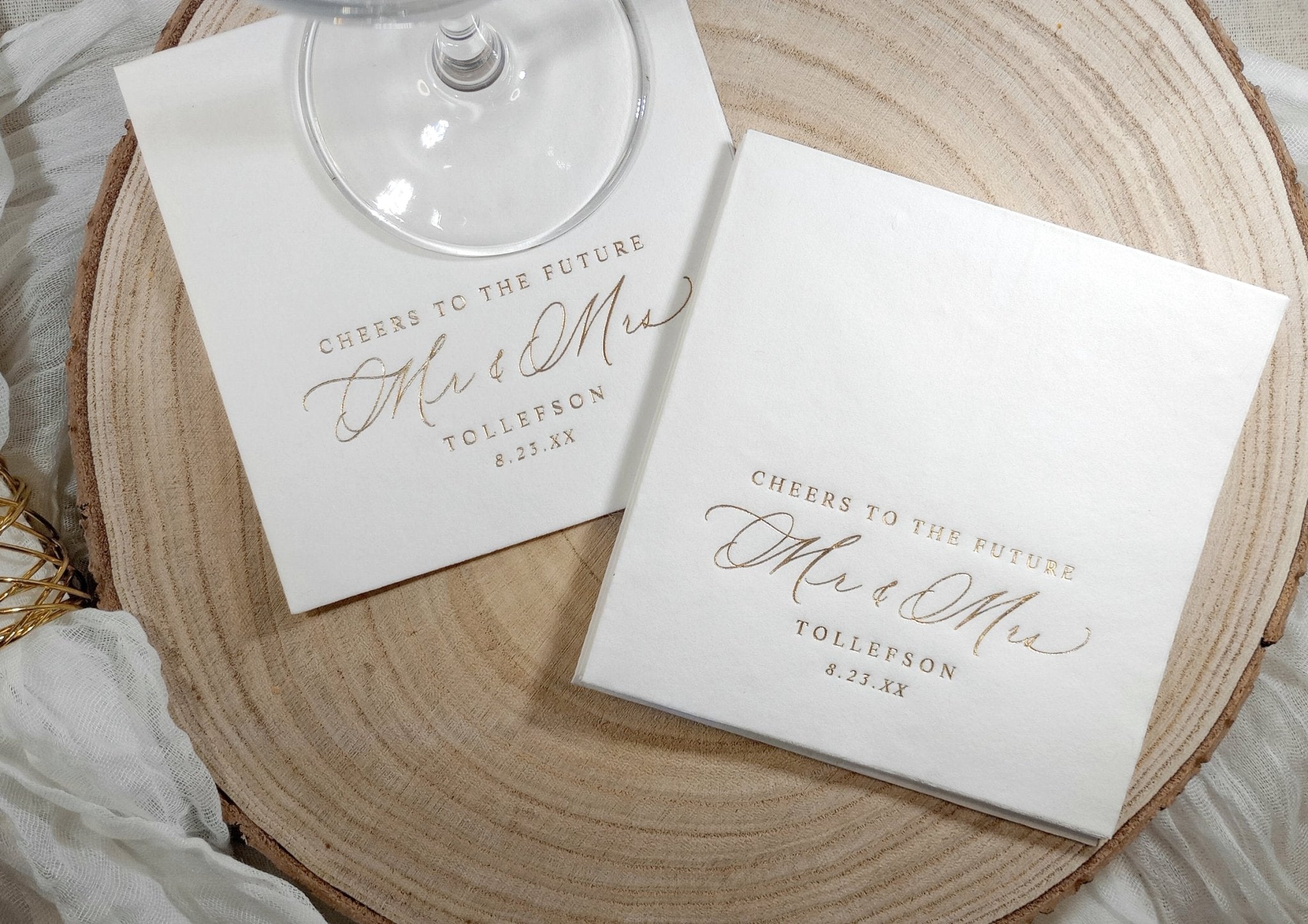 Close-up of calligraphy engagement napkin with elegant gold foil.