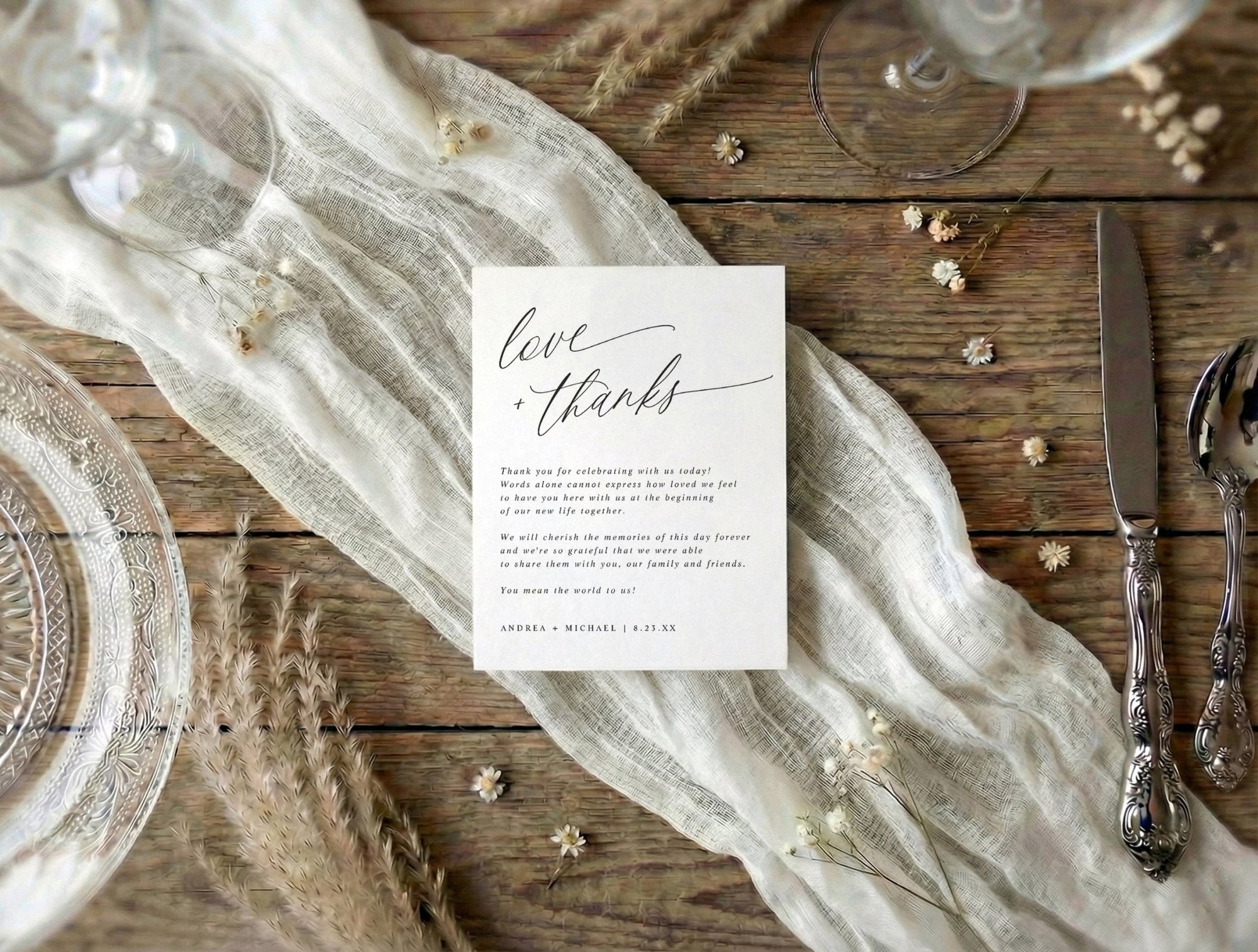 Flat thank you card with 'love & thanks' text on a rustic wooden wedding reception able with lace and silverware.