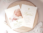 Elegant gold cross baptism invitation with “God Bless” calligraphy and baby photo back design on a wooden surface