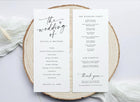 Wedding program on a wooden slice with a white background