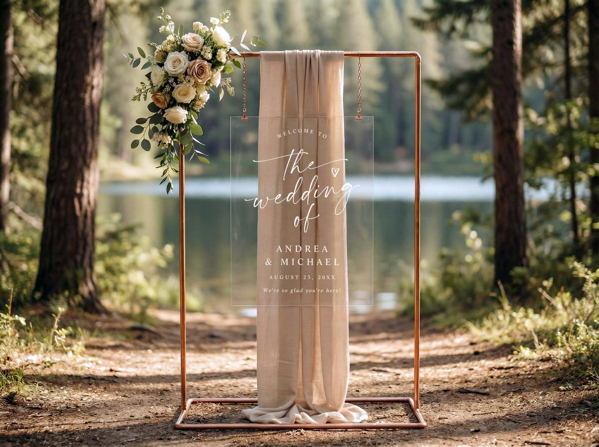 Clear acrylic wedding welcome sign with white handwritten script and heart detail