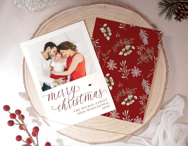 Elegant flat Christmas card with family photo and botanical watercolor greenery.