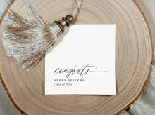 Graduation congratulations napkin with tassel on a wooden surface