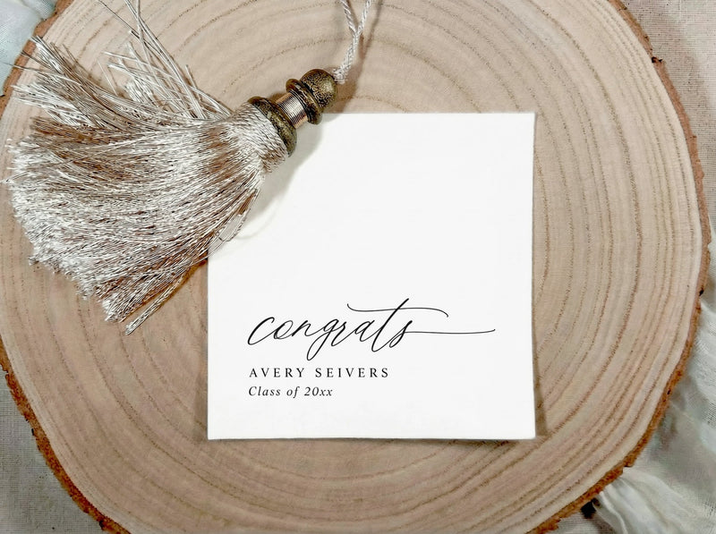 Graduation congratulations napkin with tassel on a wooden surface